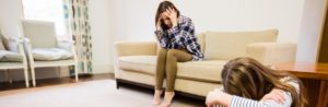 Mother and daughter distressed in living room