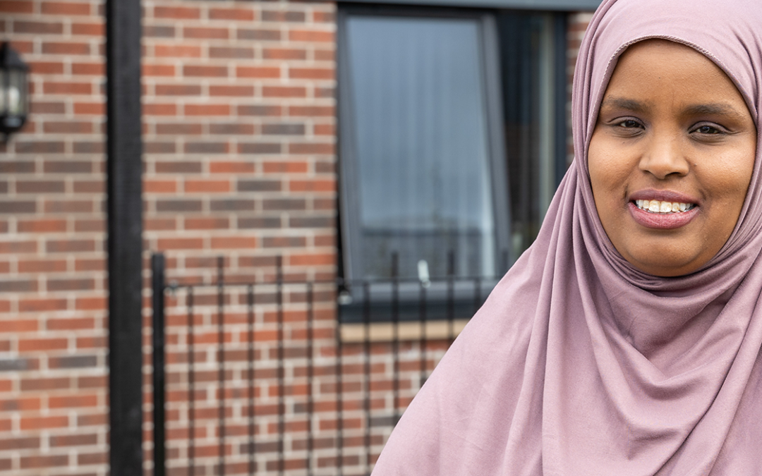 WWH resident wearing head scarf smiling outside front of property (2)