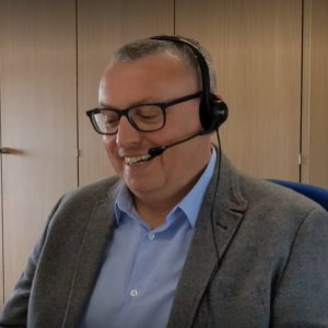 WWH staff member smiling whilst talking on a headset
