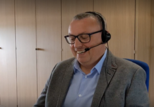 WWH staff member smiling whilst talking on a headset